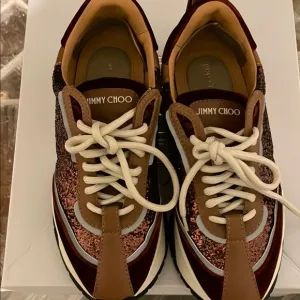 Jimmy Choo Women's Glitter Sneakers - Brown. Gently used. Some marks .