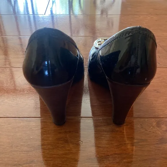Tory Burch Black Patent Leather Logo Embellished Wedge Pumps.